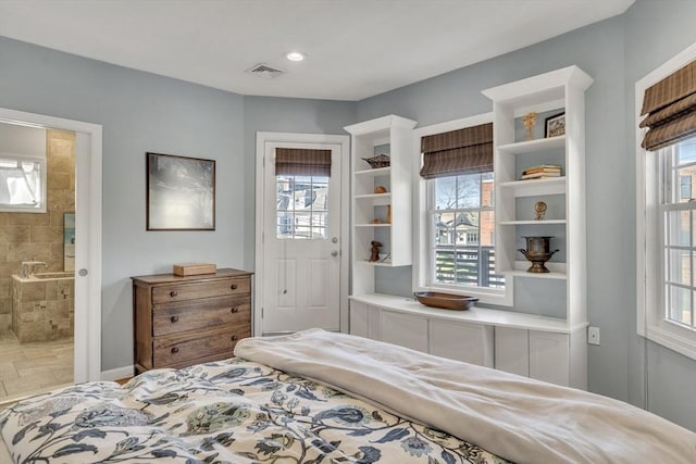 bedroom with visible vents and multiple windows