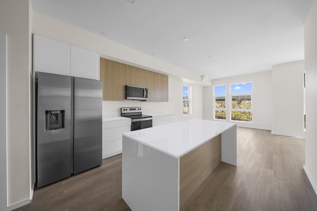 546 Saratoga Unit 1, Boston, MA 02128 - kitchen with appliances with stainless steel finishes, modern cabinets, light countertops, and wood finished floors