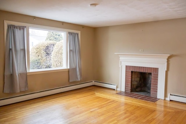 unfurnished living room with a baseboard radiator, a fireplace, and wood finished floors