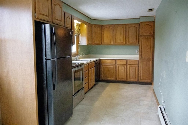 kitchen with brown cabinetry, light countertops, black appliances, a baseboard heating unit, and a sink