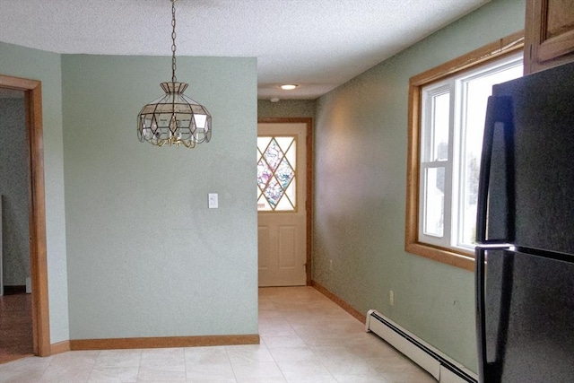 interior space with baseboards, baseboard heating, and a textured ceiling