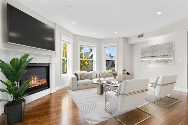 22 Chickatawbut St Unit 2, Boston, MA 02122 - living room featuring recessed lighting, visible vents, a glass covered fireplace, and wood finished floors
