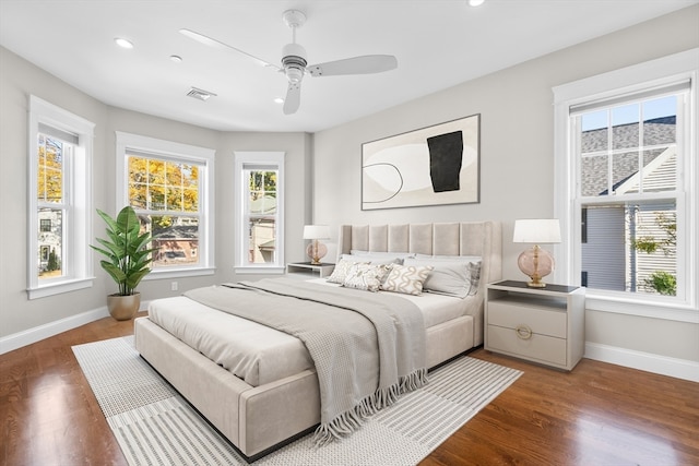 bedroom with dark hardwood / wood-style floors and ceiling fan