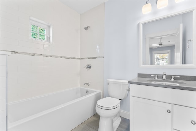 full bathroom with toilet, tiled shower / bath combo, vanity, and ceiling fan