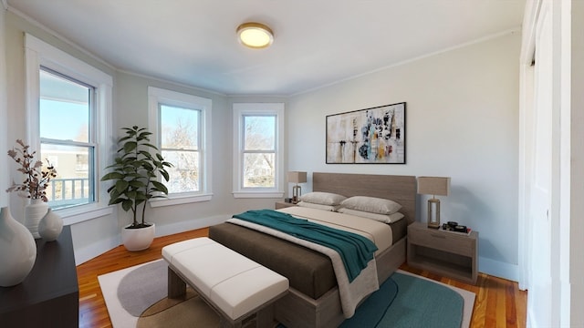 bedroom featuring wood-type flooring and ornamental molding