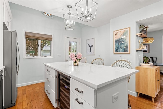 55 Rosemont Rd, Weymouth, MA 02191 - kitchen featuring beverage cooler, freestanding refrigerator, light wood finished floors, and light countertops