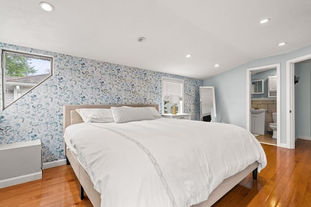 55 Rosemont Rd, Weymouth, MA 02191 - bedroom with wallpapered walls, wood-type flooring, multiple windows, recessed lighting, and connected bathroom