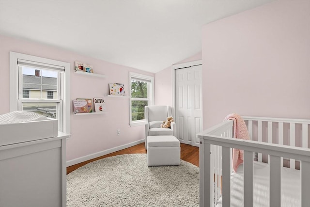 55 Rosemont Rd, Weymouth, MA 02191 - bedroom featuring wood finished floors, lofted ceiling, a closet, and a crib