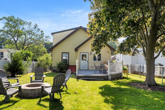 55 Rosemont Rd, Weymouth, MA 02191 - back of property with an outdoor fire pit, a deck, and a fenced backyard