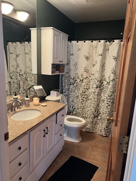 106 Shaw Rd, Goshen, MA 01330 - full bathroom with tile patterned floors, vanity, toilet, and a shower with curtain