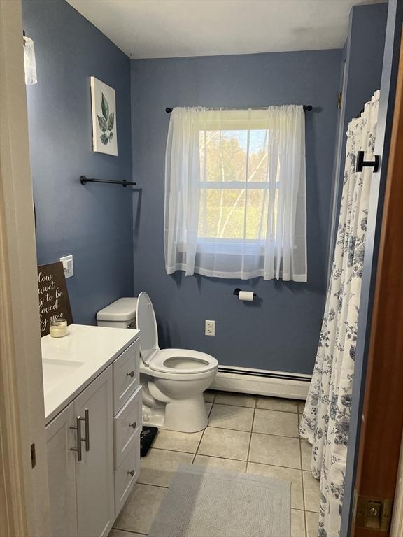 106 Shaw Rd, Goshen, MA 01330 - bathroom featuring a baseboard radiator, tile patterned flooring, vanity, and toilet
