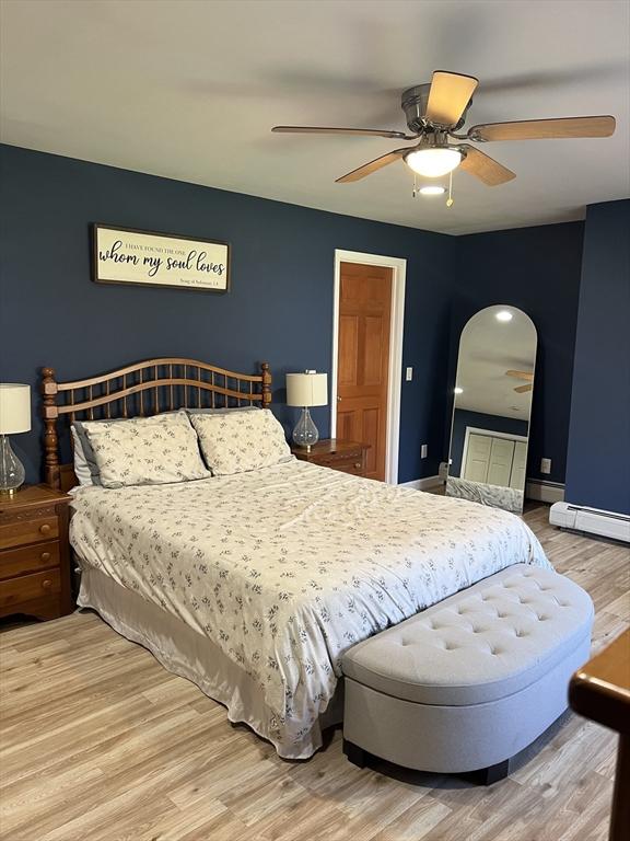 106 Shaw Rd, Goshen, MA 01330 - bedroom with wood finished floors, arched walkways, ceiling fan, and baseboards