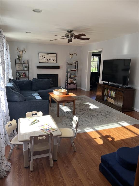 106 Shaw Rd, Goshen, MA 01330 - living room with a ceiling fan, wood finished floors, a fireplace, and baseboards