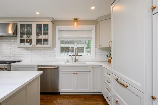 kitchen featuring stainless steel dishwasher, wall chimney exhaust hood, a sink, tasteful backsplash, and light countertops