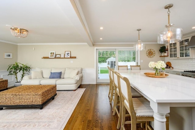 living area with ornamental molding, dark wood-style floors, wainscoting, and recessed lighting