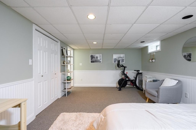 bedroom featuring wainscoting, a drop ceiling, carpet, and recessed lighting