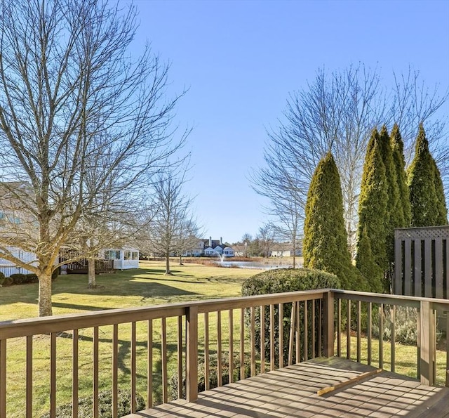 wooden deck with a lawn