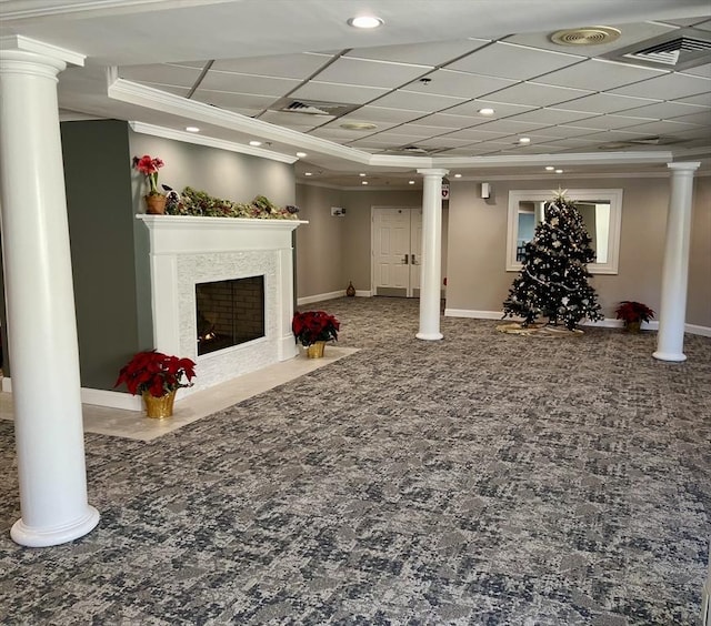 basement featuring carpet floors, visible vents, and crown molding