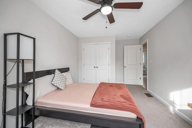 bedroom featuring carpet floors, a closet, visible vents, ceiling fan, and baseboards