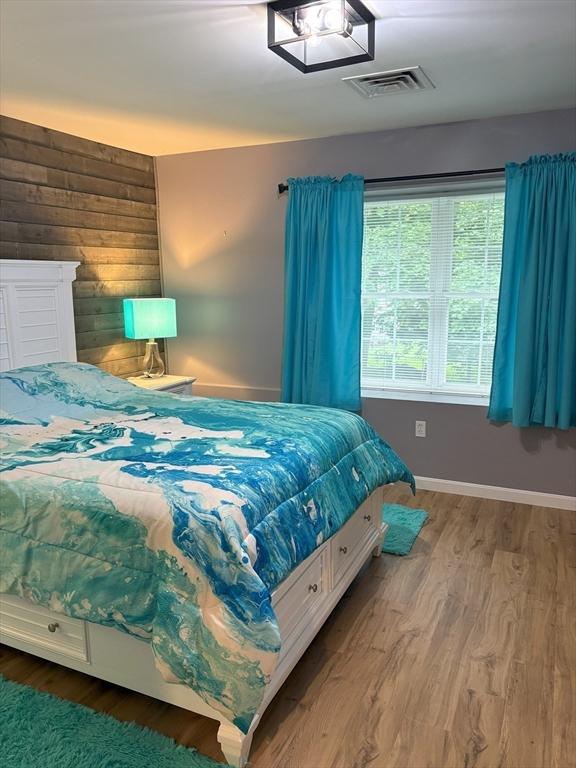 48 Phillips Rd Unit 17, Holden, MA 01520 - bedroom featuring wood finished floors and wood walls