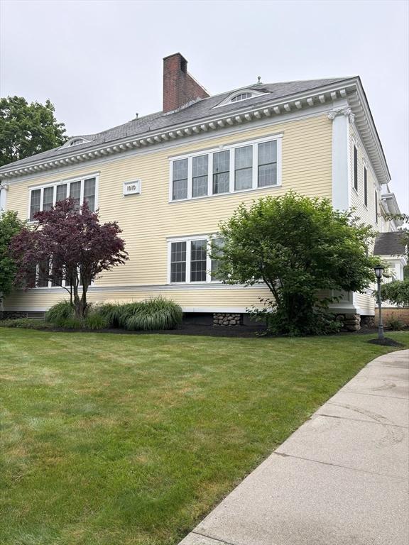 48 Phillips Rd Unit 17, Holden, MA 01520 - view of side of property featuring a lawn and a chimney