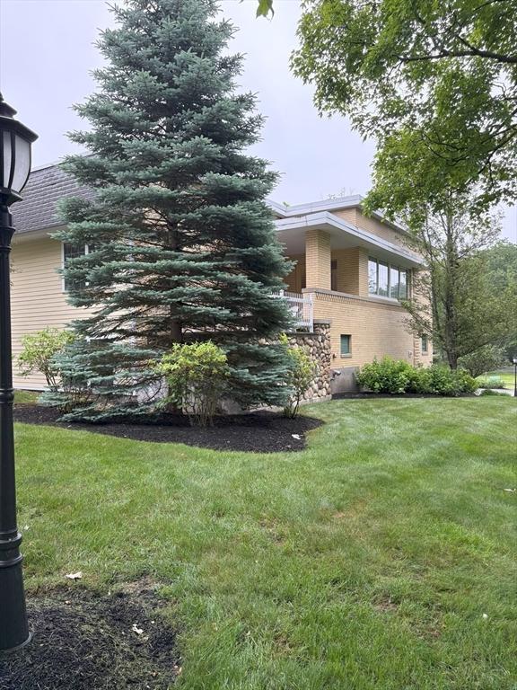 48 Phillips Rd Unit 17, Holden, MA 01520 - view of side of property featuring a lawn and brick siding