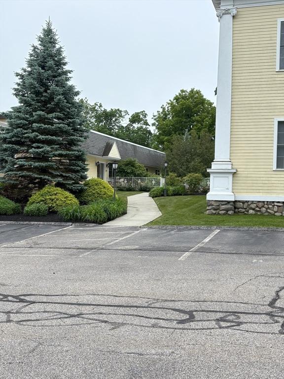 48 Phillips Rd Unit 17, Holden, MA 01520 - view of side of home with uncovered parking and a lawn