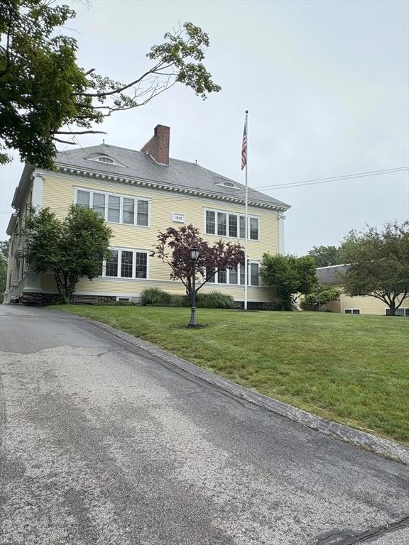 48 Phillips Rd Unit 17, Holden, MA 01520 - view of front facade with a front lawn and a chimney