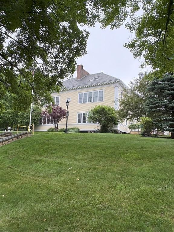 48 Phillips Rd Unit 17, Holden, MA 01520 - rear view of house with a chimney and a yard