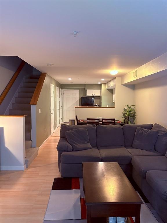 48 Phillips Rd Unit 17, Holden, MA 01520 - living area with stairs and light wood-style floors