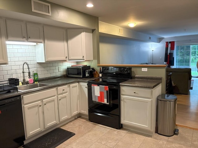 48 Phillips Rd Unit 17, Holden, MA 01520 - kitchen with black appliances, a peninsula, dark countertops, backsplash, and recessed lighting