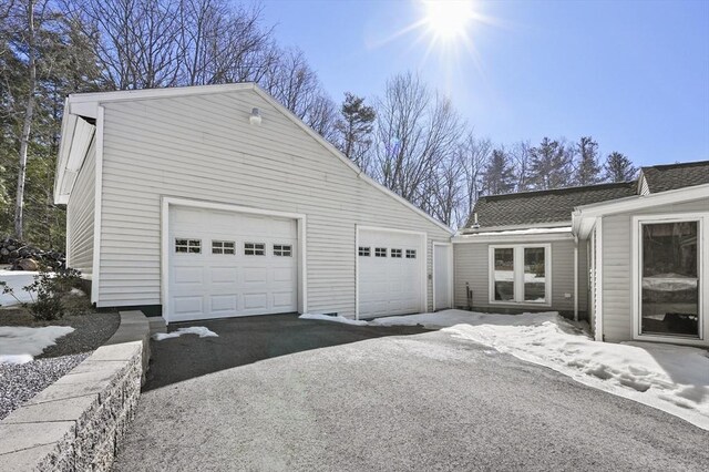view of side of home with a shingled roof