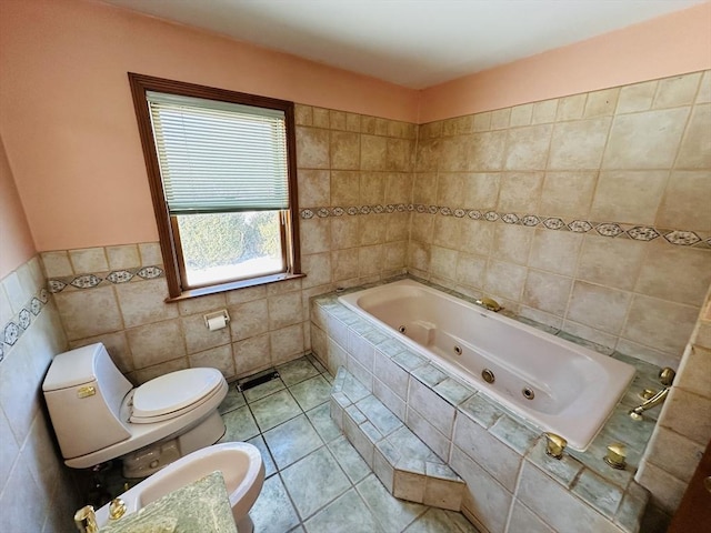 bathroom with toilet, tile patterned flooring, a jetted tub, and tile walls