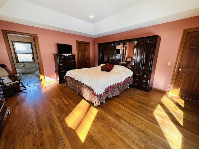 bedroom featuring baseboards and light wood finished floors