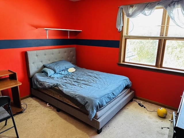 bedroom featuring baseboards and light colored carpet