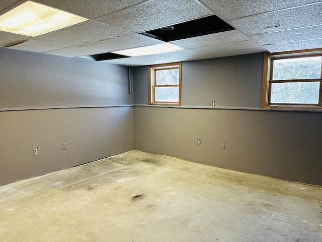 basement with a paneled ceiling