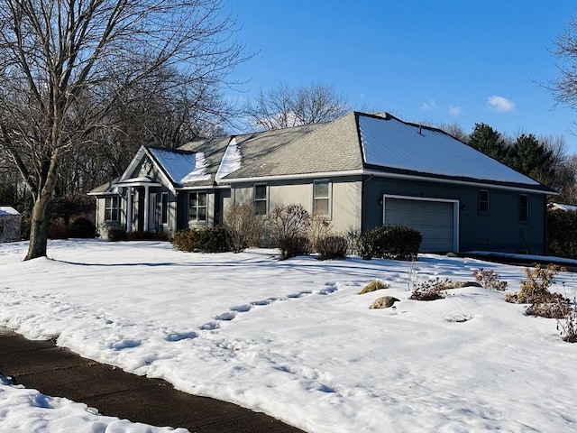 view of front of property featuring an attached garage and stucco siding