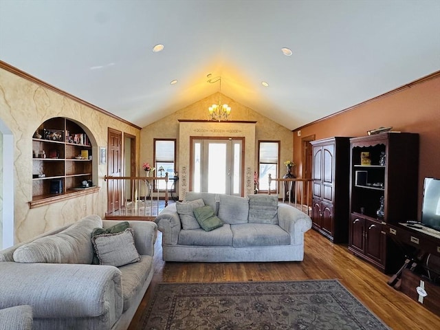 living room with built in features, vaulted ceiling, an inviting chandelier, and wood finished floors