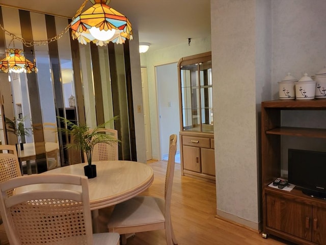 dining space with light wood-type flooring