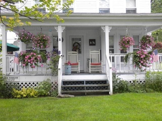1123 E St, Ludlow, MA 01056 - view of exterior entry with covered porch and a yard