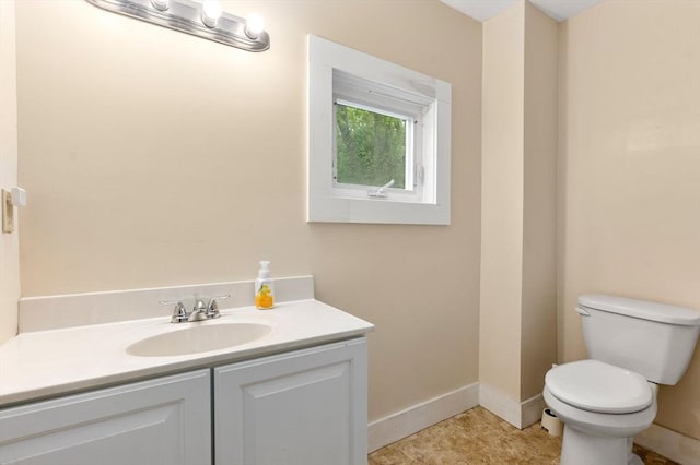 1123 E St, Ludlow, MA 01056 - half bathroom featuring toilet, vanity, and baseboards