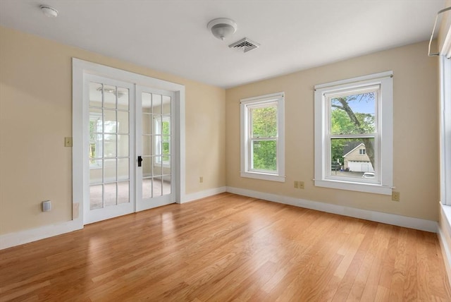 1123 E St, Ludlow, MA 01056 - unfurnished room featuring light wood-style floors, baseboards, a smoke detector, and french doors
