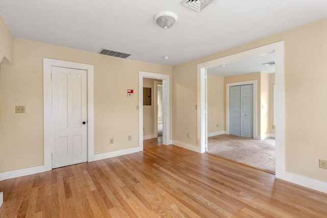 1123 E St, Ludlow, MA 01056 - unfurnished bedroom featuring electric panel, light wood-type flooring, baseboards, and a closet