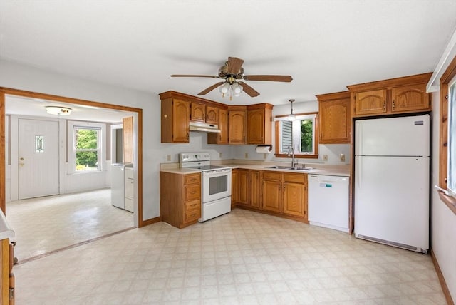 1123 E St, Ludlow, MA 01056 - kitchen with white appliances, under cabinet range hood, a sink, and light countertops