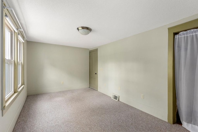 1123 E St, Ludlow, MA 01056 - empty room featuring carpet, baseboards, and a textured ceiling