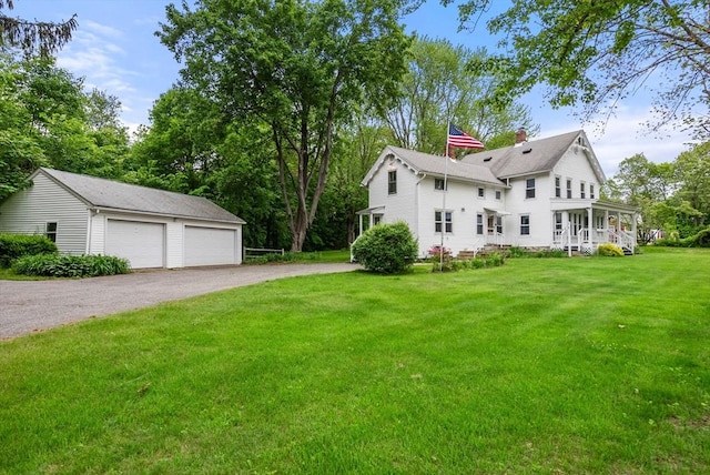 1123 E St, Ludlow, MA 01056 - view of side of property featuring a detached garage, a yard, an outdoor structure, and a chimney