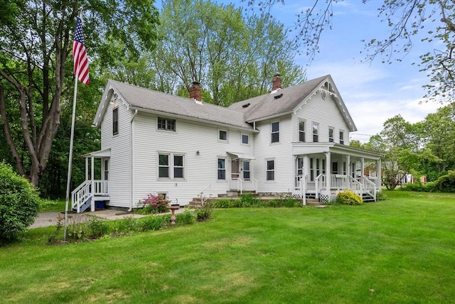 1123 E St, Ludlow, MA 01056 - rear view of property with a porch, a chimney, and a lawn