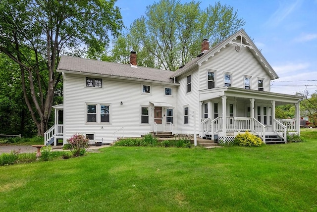 1123 E St, Ludlow, MA 01056 - rear view of property featuring a chimney, a porch, and a lawn