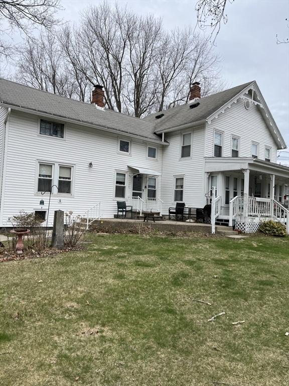1123 E St, Ludlow, MA 01056 - rear view of house featuring a chimney, a lawn, a porch, and a patio