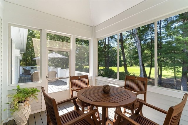 sunroom featuring vaulted ceiling